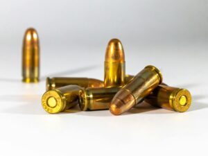 A still life of bullets displayed on a white background, highlighting their metallic texture and shape.